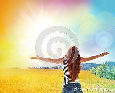 Young girl spreading hands with joy and inspiration Stock Photo