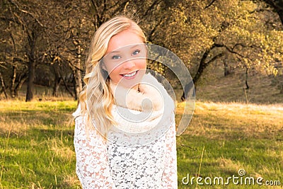 Young Girl Standing in Green Field Stock Photo