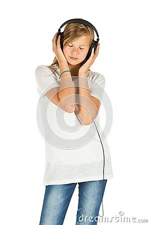 Young girl standing listening to music over white background Stock Photo