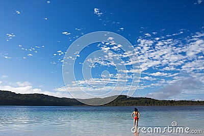 Young girl standing in the tranquil lake Stock Photo