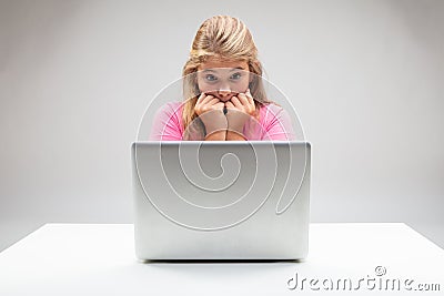 Young girl staring aghast at her laptop Stock Photo