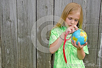 Young girl with stethoscope on world globe Stock Photo