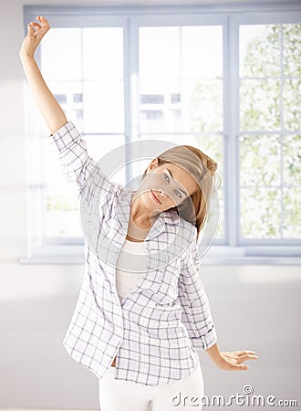 Young girl stretching in the morning in pyjama Stock Photo