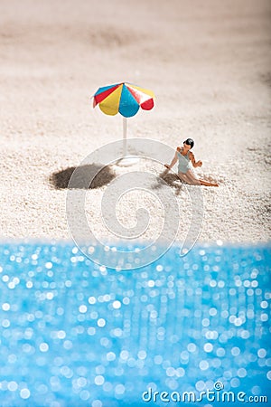 Young girl sunbathing alone on a sandy beach Stock Photo