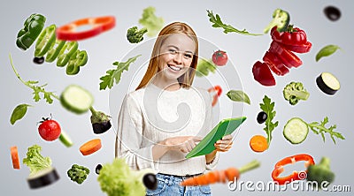 Young girl with tablet computer on grey background, collage with flying veggies. Panorama Stock Photo