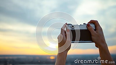 Young girl taking sunset photo in NYC Stock Photo