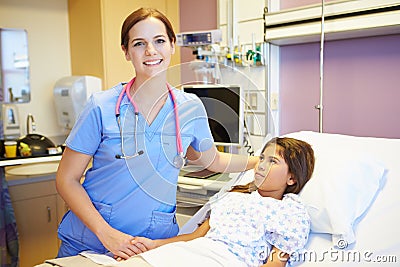 Young Girl Talking To Female Nurse In Hospital Room Stock Photo