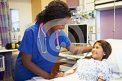 Young Girl Talking To Female Nurse In Hospital Room Stock Photo