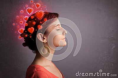 Young girl thinking about love with red hearts Stock Photo