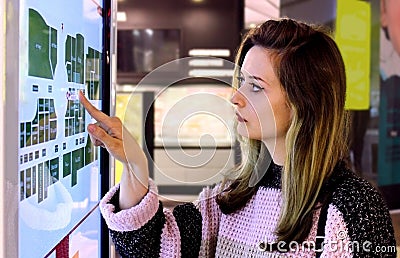 Young girl touching interactive navigation system at mall Stock Photo