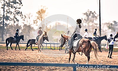 Young girl is training to ride a horse horse is in the practice field Editorial Stock Photo