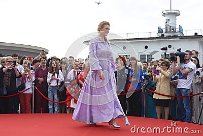 Young girl in Ukrainian national embroidered dress posing in front of a crowd of people. Celebration of Embroidered Editorial Stock Photo