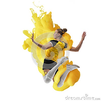 Young girl volleyball player in explosion of yellow colored neon luiquid fluid isolated on white background. Stock Photo
