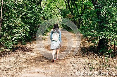 young girl walking along a sandy path in the city park Editorial Stock Photo