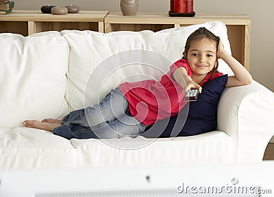 Young Girl Watching Television at Home Stock Photo