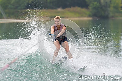 Young girl water skiing on slalom course Stock Photo