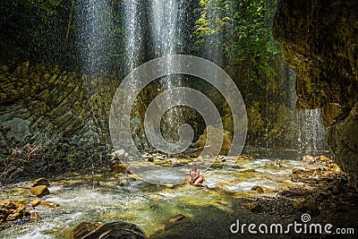 Young girl in waterfall near Panta Vrexei in Evritania, Greece Stock Photo