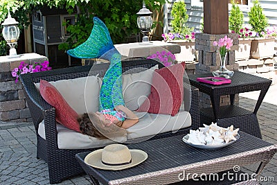 Young girl wearing a blue mermaid tail Stock Photo