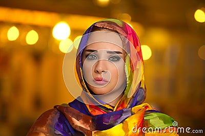 Young girl wearing hijab against bokeh lights Stock Photo