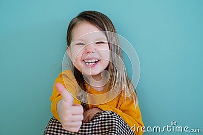 A young girl wearing a yellow shirt Stock Photo