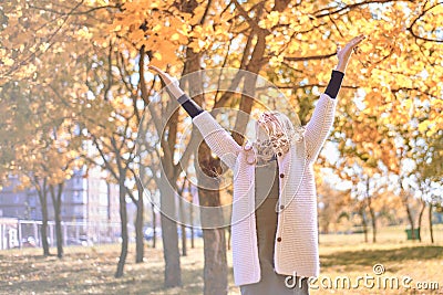 Young girl welcomes autumn. teenager raised her hands up. hello autumn concept Stock Photo