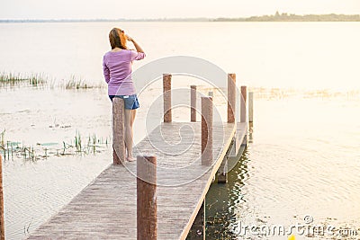 young girl on a wooden bridge Stock Photo