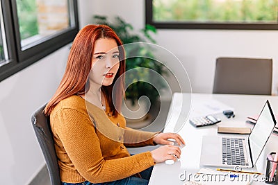 Young girl working at home with a laptop Stock Photo