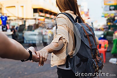 Young girlfriend tourist holding hand of boyfriend Stock Photo