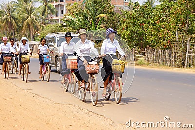 Young girls bicycle home from school Editorial Stock Photo
