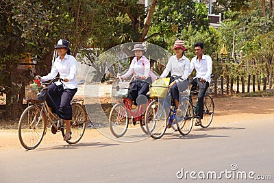 Young girls bicycle home from school Editorial Stock Photo