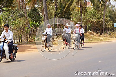 Young girls bicycle home from school Editorial Stock Photo