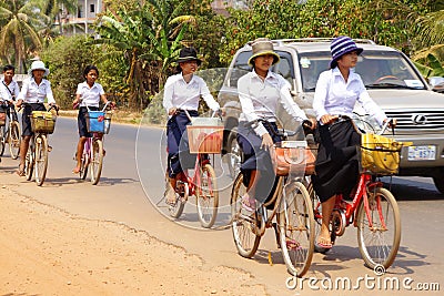 Young girls bicycle home from school Editorial Stock Photo