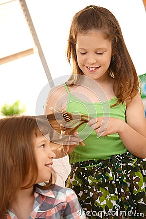 Young girls enjoying combing hair Stock Photo