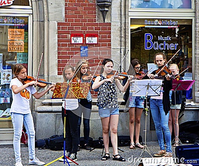 Young girls play violin on the streets of Munich center Editorial Stock Photo