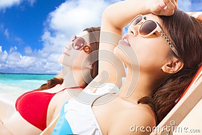 Young girls sunbathing and lying on a beach chair Stock Photo