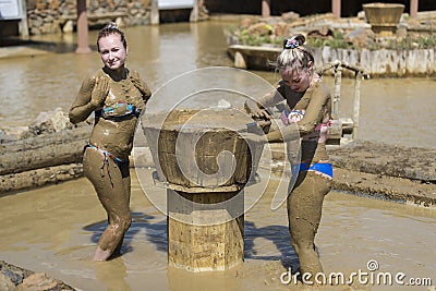 Young girls take mud baths Stock Photo