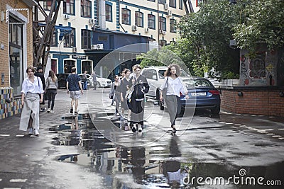 Young girls walk fast down the street Editorial Stock Photo