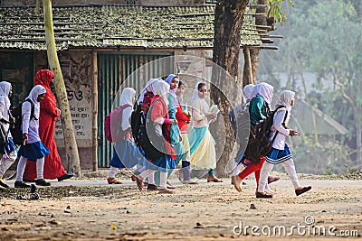 Young girls are walking together to attend the village school Editorial Stock Photo