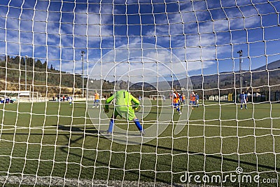 A young Goalkeeper caught in action is preparing himself to challange the opponent Editorial Stock Photo