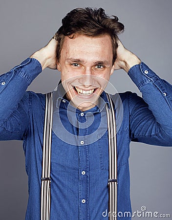 Young goofy man with pimples pointing in studio Stock Photo