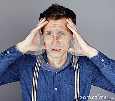 Young goofy man with pimples pointing in studio Stock Photo