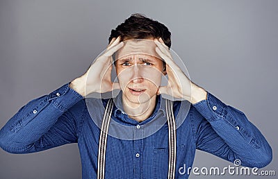 Young goofy man with pimples pointing in studio Stock Photo