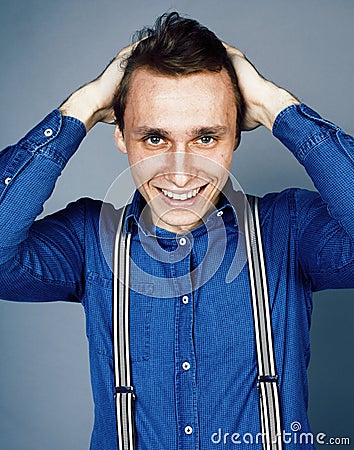 Young goofy man with pimples pointing in studio Stock Photo