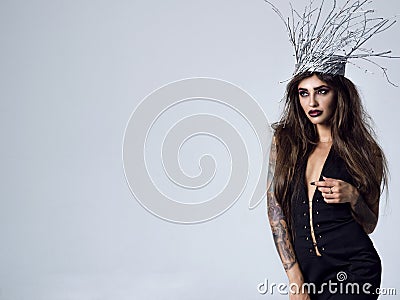 Young gorgeous woman in an image of wood witch Stock Photo