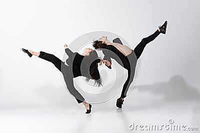 Young and graceful ballet dancers in minimal black style isolated on white studio background Stock Photo