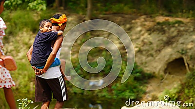 A Young grand father holding his cute child on shoulders. Family spending time together.Happy Grandfather's day Editorial Stock Photo