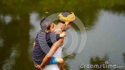 A Young grand father holding his cute child on shoulders. Family spending time together.Happy Grandfather's day Editorial Stock Photo