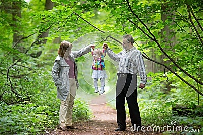 Young grandparents playing with their baby granddaughter Stock Photo