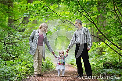 Young grandparents walking with their baby granddaughter Stock Photo