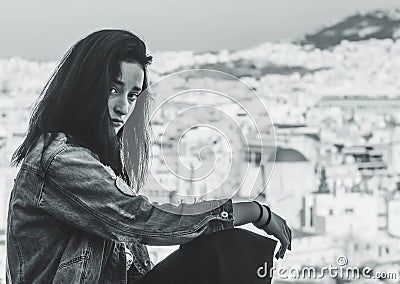 Young Greek girl on the background of the panorama of the city in the tourist area of Athens Anafiotika in Greece Stock Photo